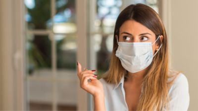 Woman with medical mask on thinking