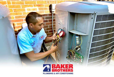 Photo of technician performing maintenance on AC unit