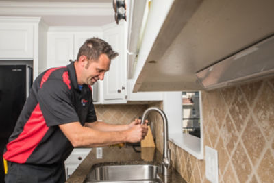 Plumber clearing a drain in a metro Atlanta home