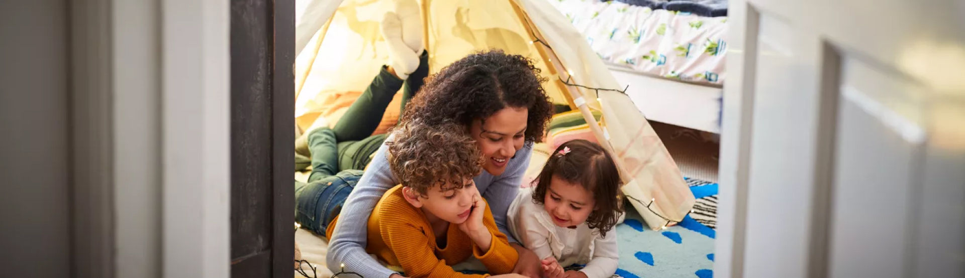 A smiling woman and two happy children