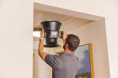 Technician doing repair in kitchen