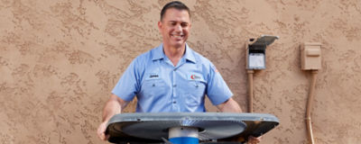 Collins HVAC tech repairing an air conditioner in Glendale, AZ