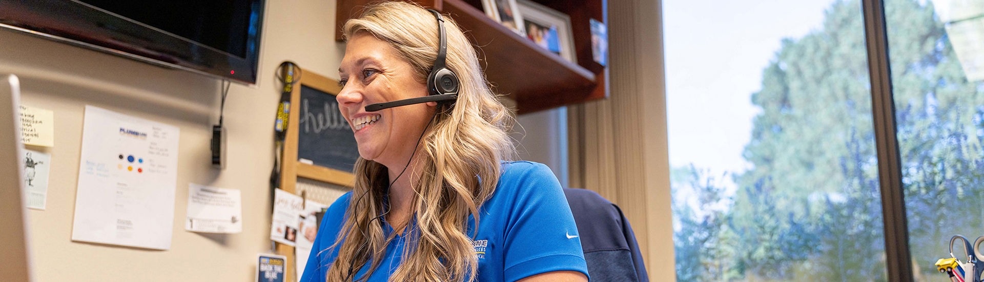 Plumbline employee in office with headset on