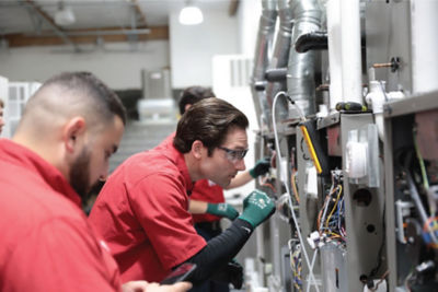 CU Student Inspecting Furnace