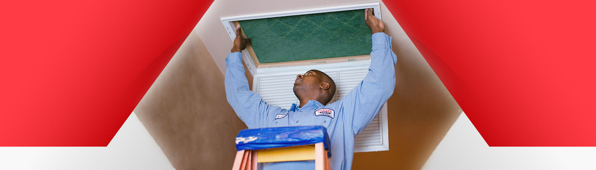 Tech on ladder replacing air filter