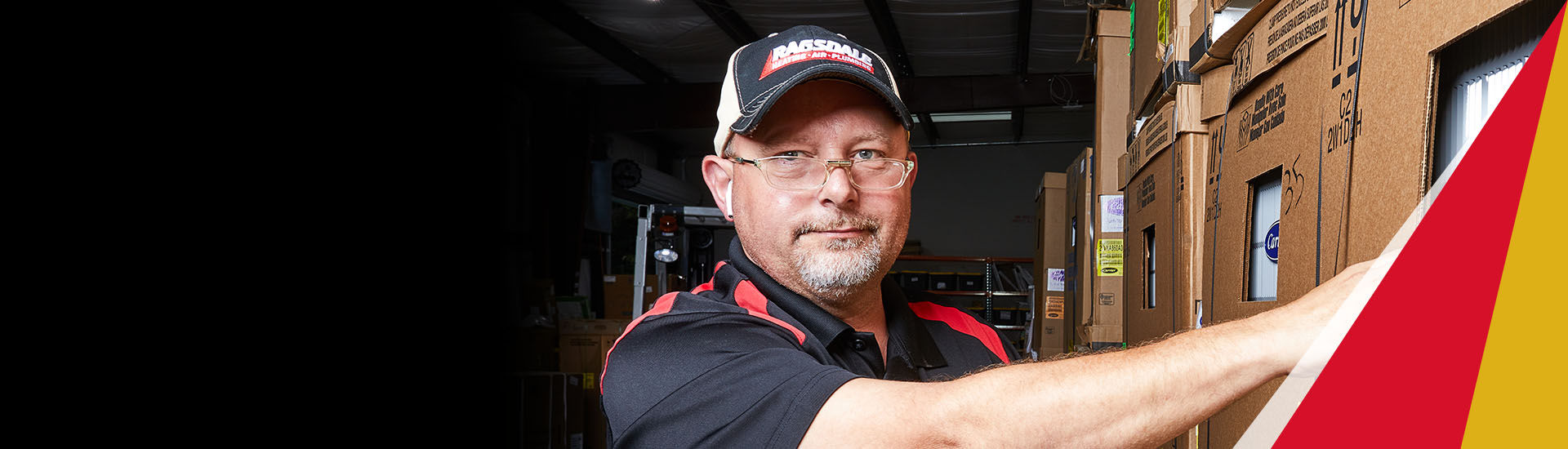 Ragsdale employee standing behind truck smiling