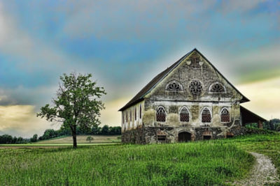 An old crumbling house on a rolling prairie