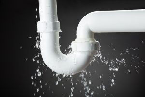 Pipe filled with water bursting with black background