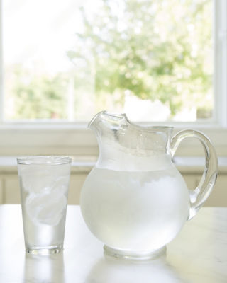 A pitcher and a glass of water on a table - Jarboes