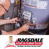 A plumber repairing a water heater