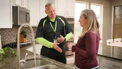 plumber homeowner in kitchen