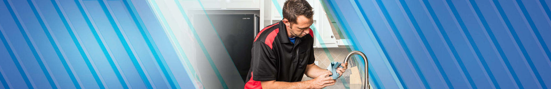 Plumber smiling next to equipment in van