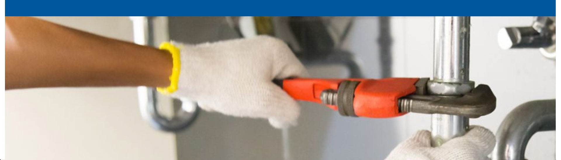 Plumber repairing a pipe on a sink drain