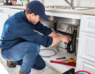 Technician doing repair in kitchen