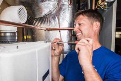 Plumber installing a water heater in a Nashville home