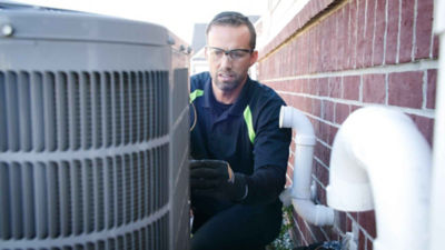 technician at heat pump