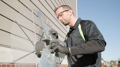 technician holding AC fan