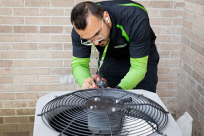 technician inspecting HVAC system