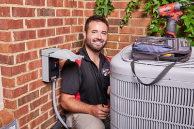 HVAC technician with a home air conditioning unit