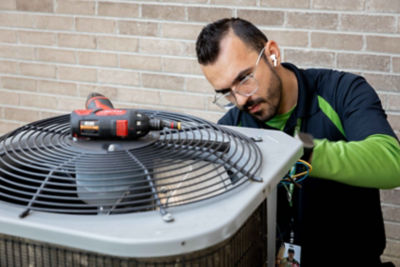 technician working on AC unit