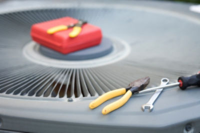 Repair tools laying on top of ac unit