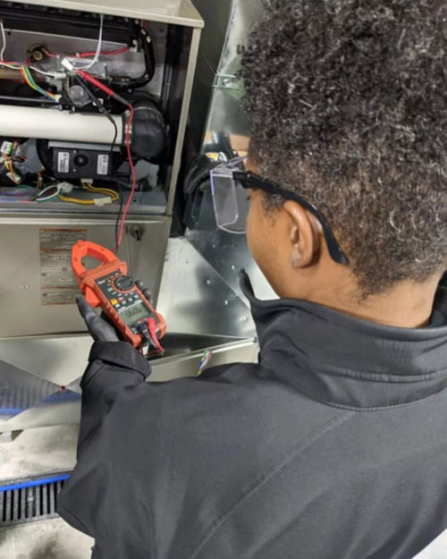 A man working on an electrical panel